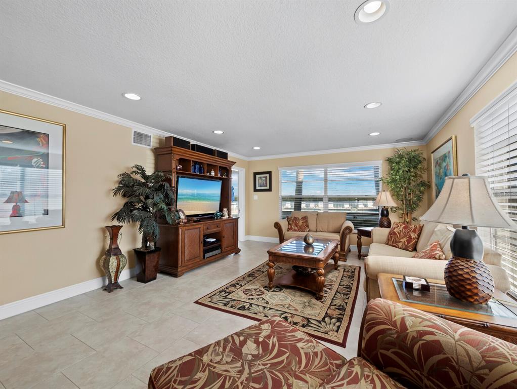 4430 Exeter Drive, Unit M108 Longboat Key, FL 34228 - Photo 11 of 65 a living room with furniture and a flat screen tv