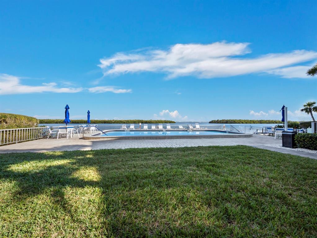 4430 Exeter Drive, Unit M108 Longboat Key, FL 34228 - Photo 13 of 65 a view of a swimming pool and an outdoor seating