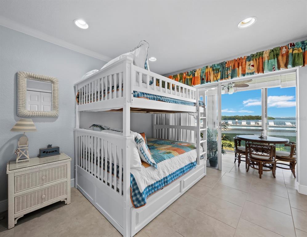 4430 Exeter Drive, Unit M108 Longboat Key, FL 34228 - Photo 16 of 65 a bedroom with furniture and a baby crib