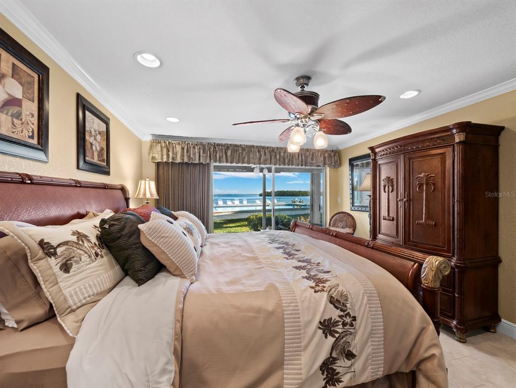 4430 Exeter Drive, Unit M108 Longboat Key, FL 34228 - Photo 21 of 65 a bedroom with a large bed and a large window