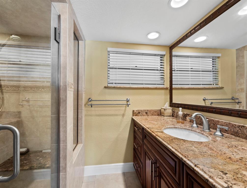 4430 Exeter Drive, Unit M108 Longboat Key, FL 34228 - Photo 25 of 65 a bathroom with a granite countertop sink and a window
