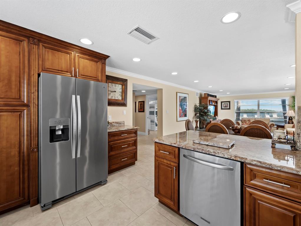 4430 Exeter Drive, Unit M108 Longboat Key, FL 34228 - Photo 3 of 65 a kitchen with stainless steel appliances granite countertop a refrigerator and a stove top oven