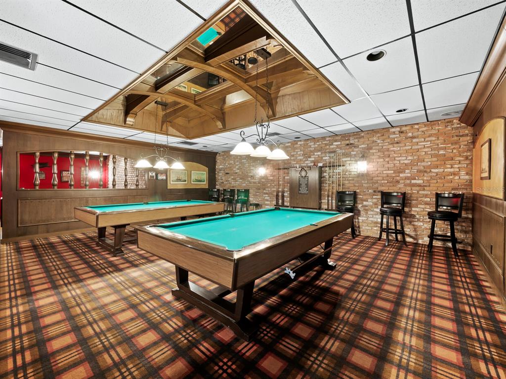 4430 Exeter Drive, Unit M108 Longboat Key, FL 34228 - Photo 43 of 65 a room with pool table and outdoor seating