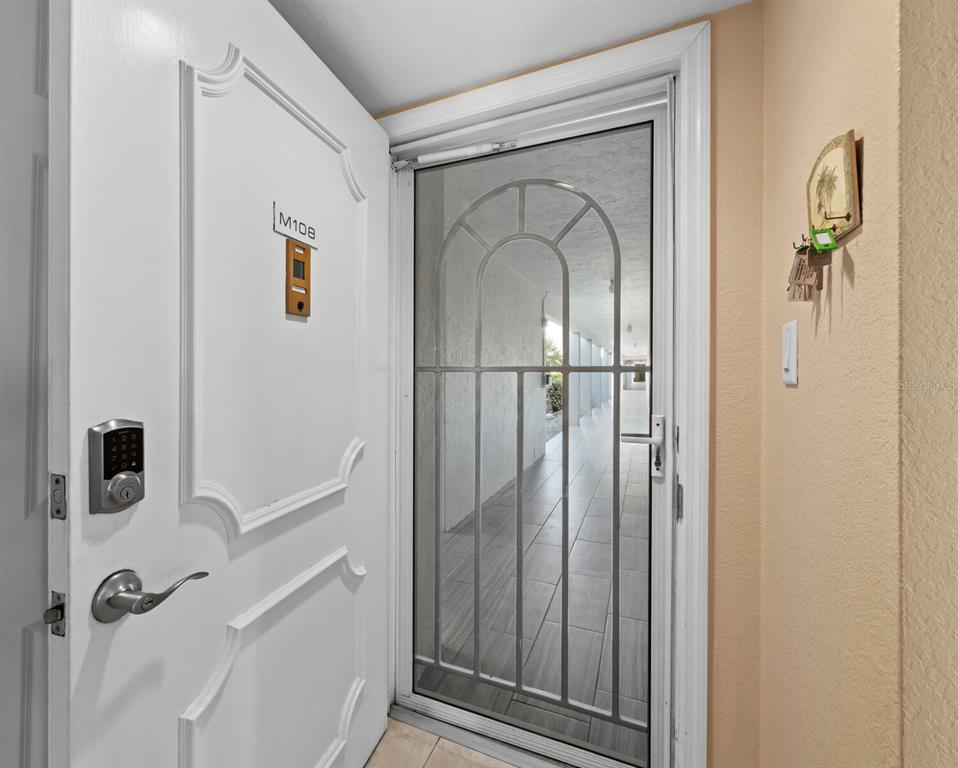 4430 Exeter Drive, Unit M108 Longboat Key, FL 34228 - Photo 5 of 65 a view of a livingroom with wooden floor and entryway