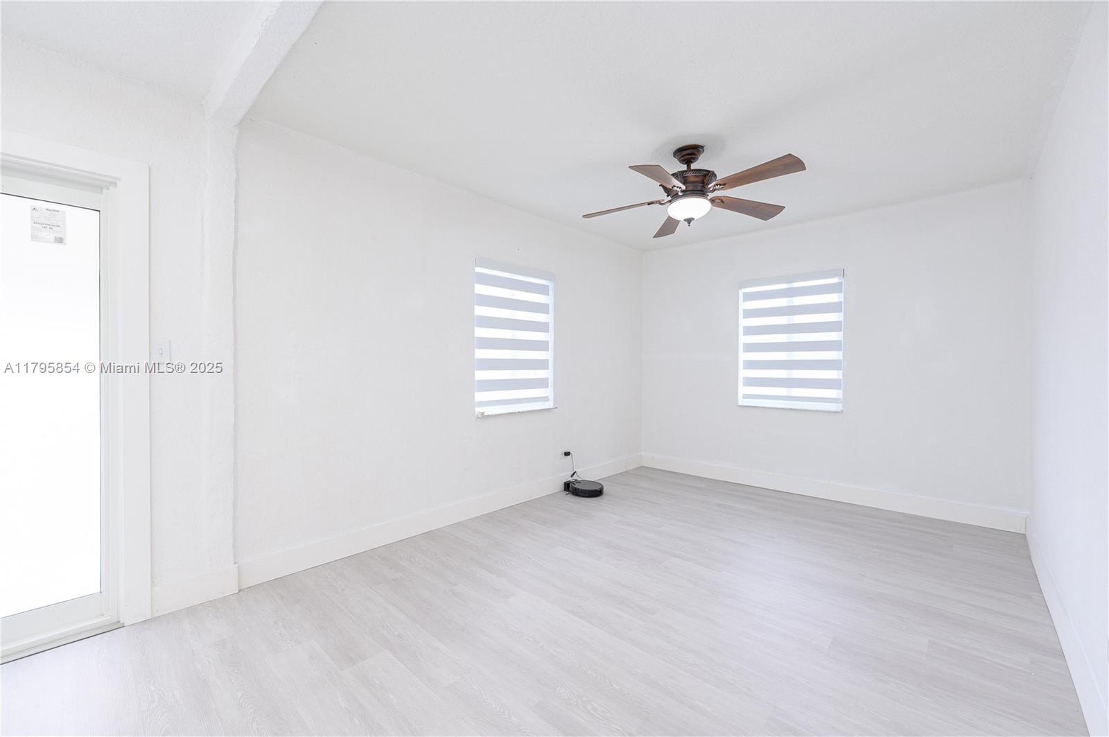 5200 Southwest 4th Street Miami, FL 33134 - Photo 13 of 35 an empty room with windows and fan
