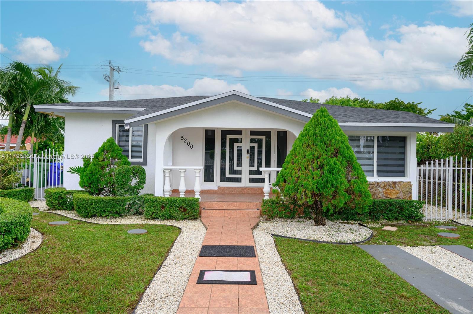 5200 Southwest 4th Street Miami, FL 33134 - Photo 2 of 35 a front view of a house with a yard