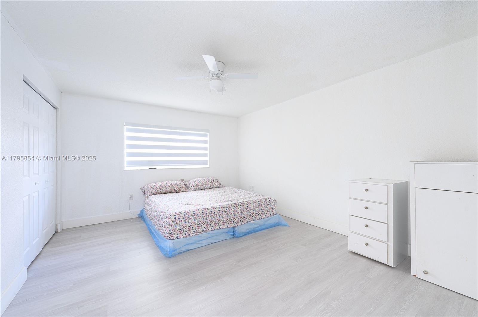 5200 Southwest 4th Street Miami, FL 33134 - Photo 26 of 35 a spacious bedroom with a bed and a window