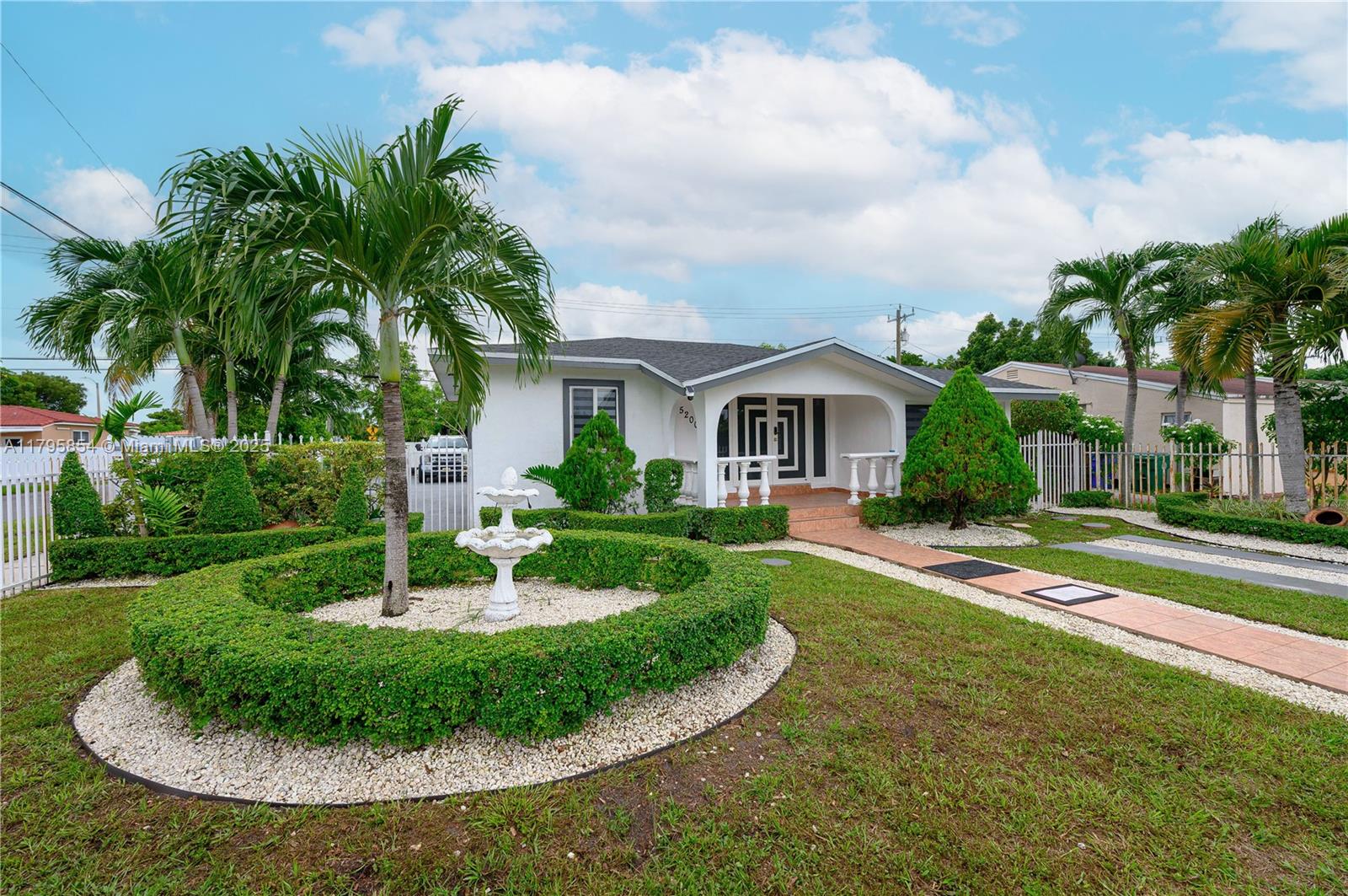 5200 Southwest 4th Street Miami, FL 33134 - Photo 3 of 35 a view of a house with a swimming pool and a yard