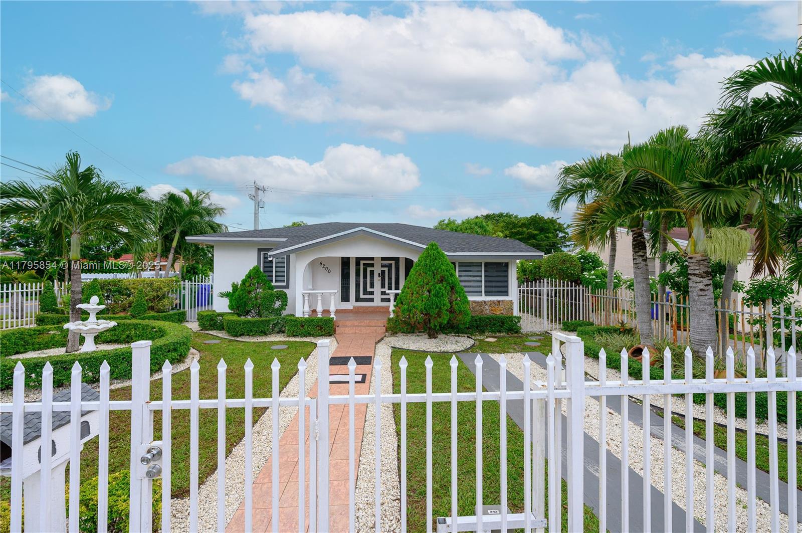 5200 Southwest 4th Street Miami, FL 33134 - Photo 5 of 35 a front view of house with yard and green space