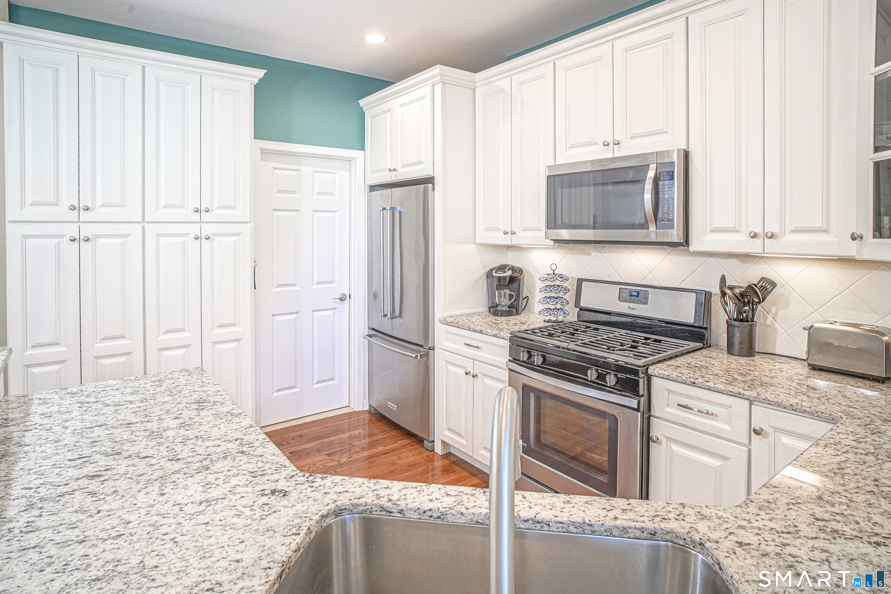 6 Lilac Lane, Unit 6 Prospect, CT 06712 - Photo 10 of 40 This Hickory model offers a built-in hutch, hardwood floors, and a door to the laundry and garage.