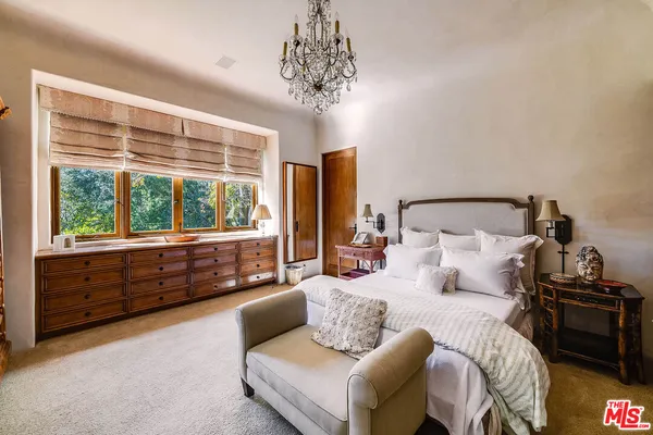 a spacious bathroom with a mirror and bathtub