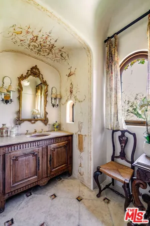 a living room with patio furniture and a chandelier