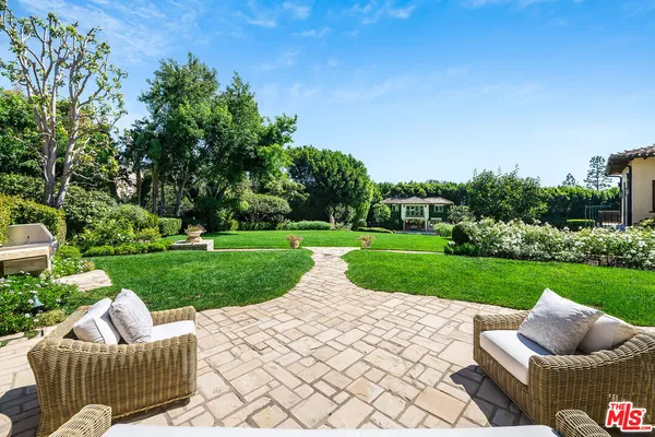 a view of a house with a yard patio and swimming pool