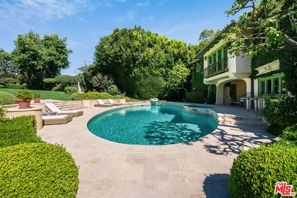 a view of a chair and table on the garden