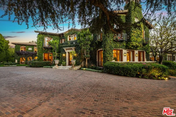 a living room with furniture chandelier and a large window