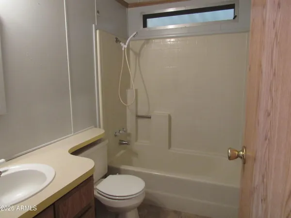 a bathroom with a granite countertop toilet sink and shower