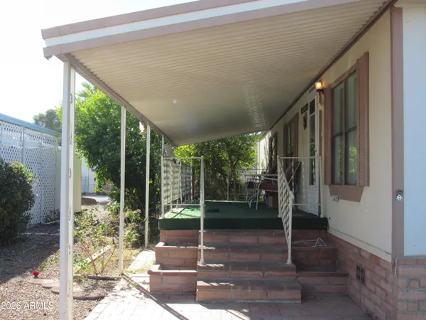 a porch with a potted plant