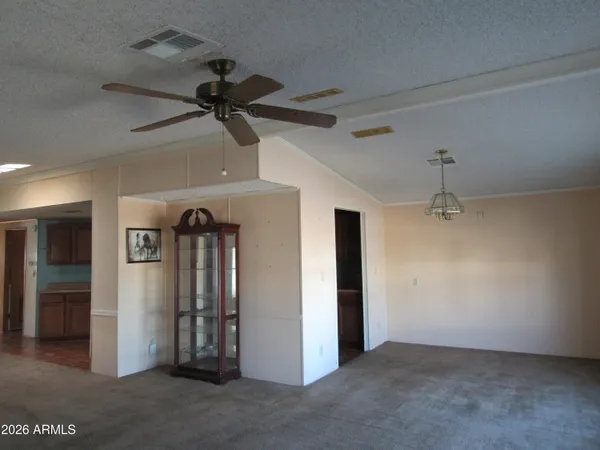 an empty room with closet and a ceiling fan
