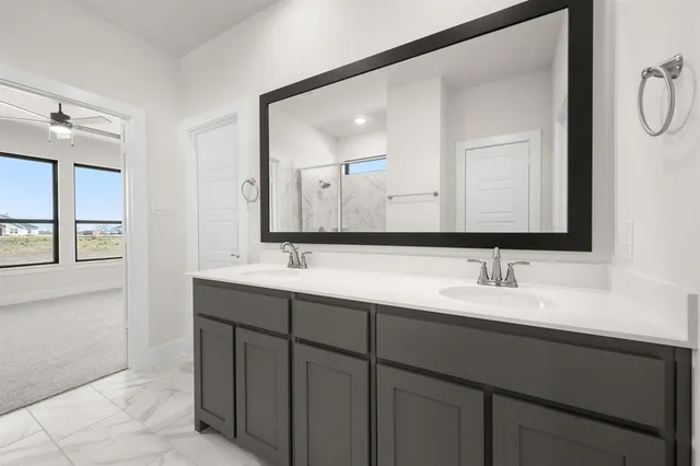 a bathroom with a double vanity sink mirror and