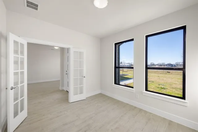 an empty room with windows and closet