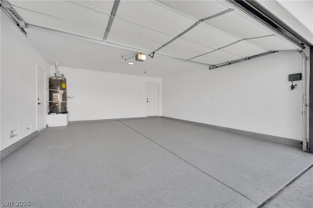 8981 Rivers Edge Drive Las Vegas, NV 89117 - Photo 53 of 69 A spacious garage features a durable, speckled concrete floor, ready for vehicles and projects.