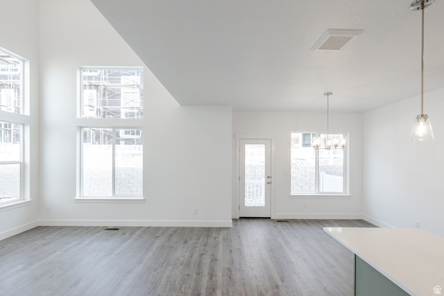 4769 Olive Avenue, Unit 411 Mapleton, UT 84664 - Photo 10 of 19 Unfurnished dining area with suspended lighting and light wood finished floors