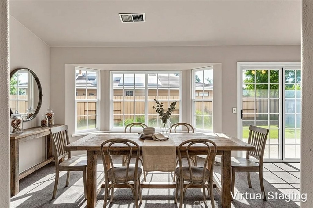 3546 Joerg Avenue Merced, CA 95340 - Photo 16 of 51 a view of a dining room with furniture a chandelier and wooden floor