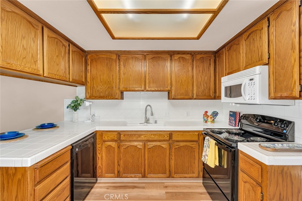 3546 Joerg Avenue Merced, CA 95340 - Photo 19 of 51 a kitchen with a sink a stove cabinets and a window