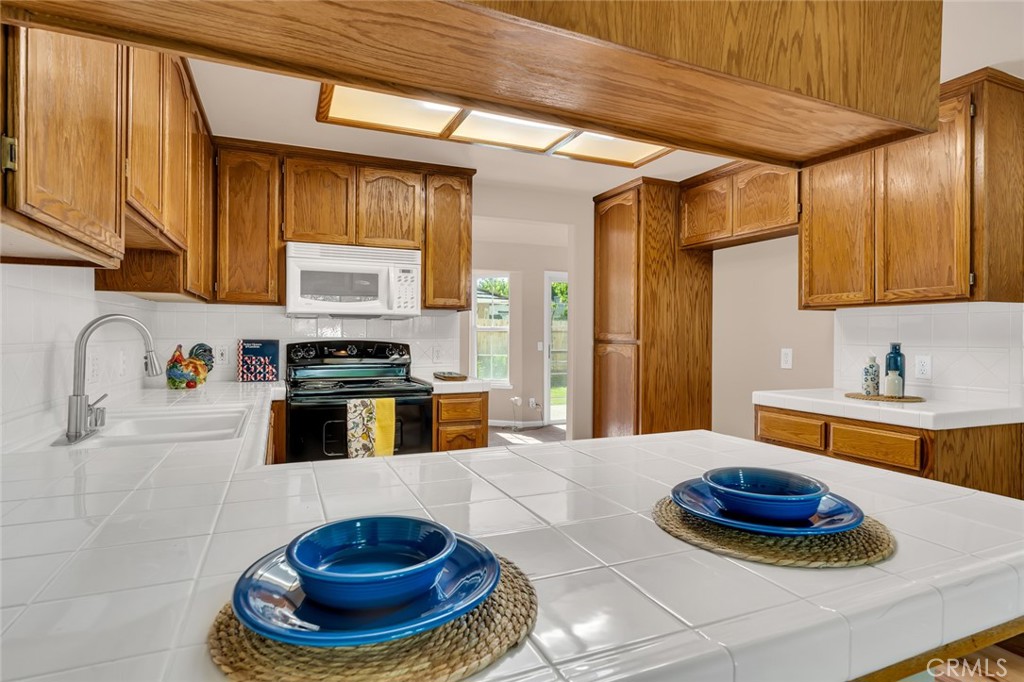 3546 Joerg Avenue Merced, CA 95340 - Photo 23 of 51 a kitchen with a stove and a microwave