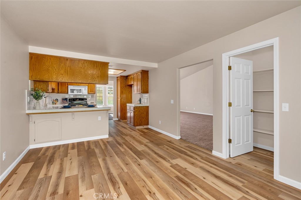 3546 Joerg Avenue Merced, CA 95340 - Photo 27 of 51 a view of a kitchen with wooden floor and a refrigerator