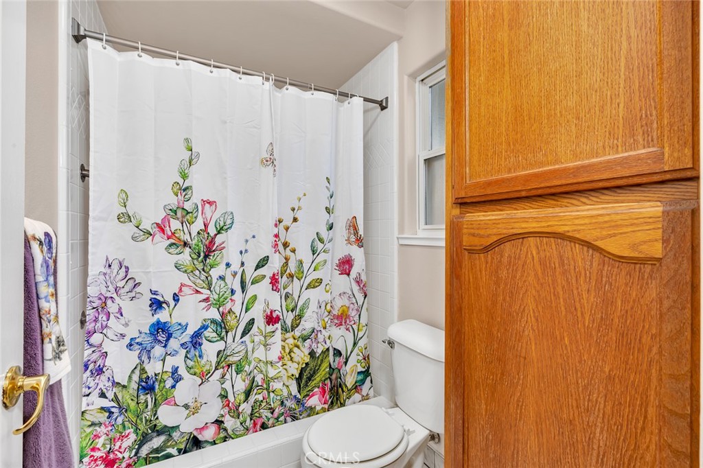 3546 Joerg Avenue Merced, CA 95340 - Photo 36 of 51 a bathroom with a sink a toilet and shower curtain