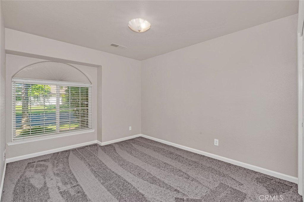 3546 Joerg Avenue Merced, CA 95340 - Photo 37 of 51 a view of an empty room with wooden floor and a window