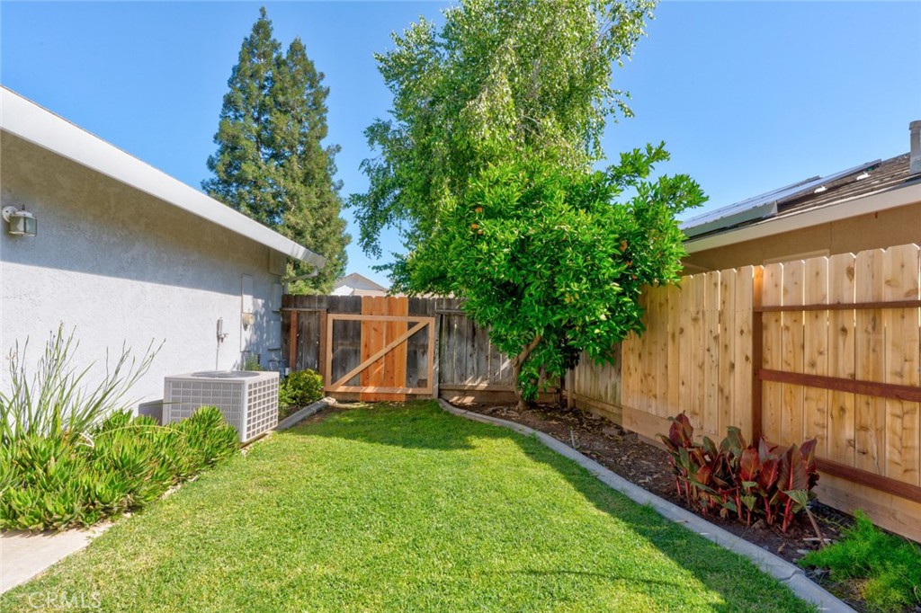 3546 Joerg Avenue Merced, CA 95340 - Photo 48 of 51 a view of a backyard with a wooden fence and a large tree