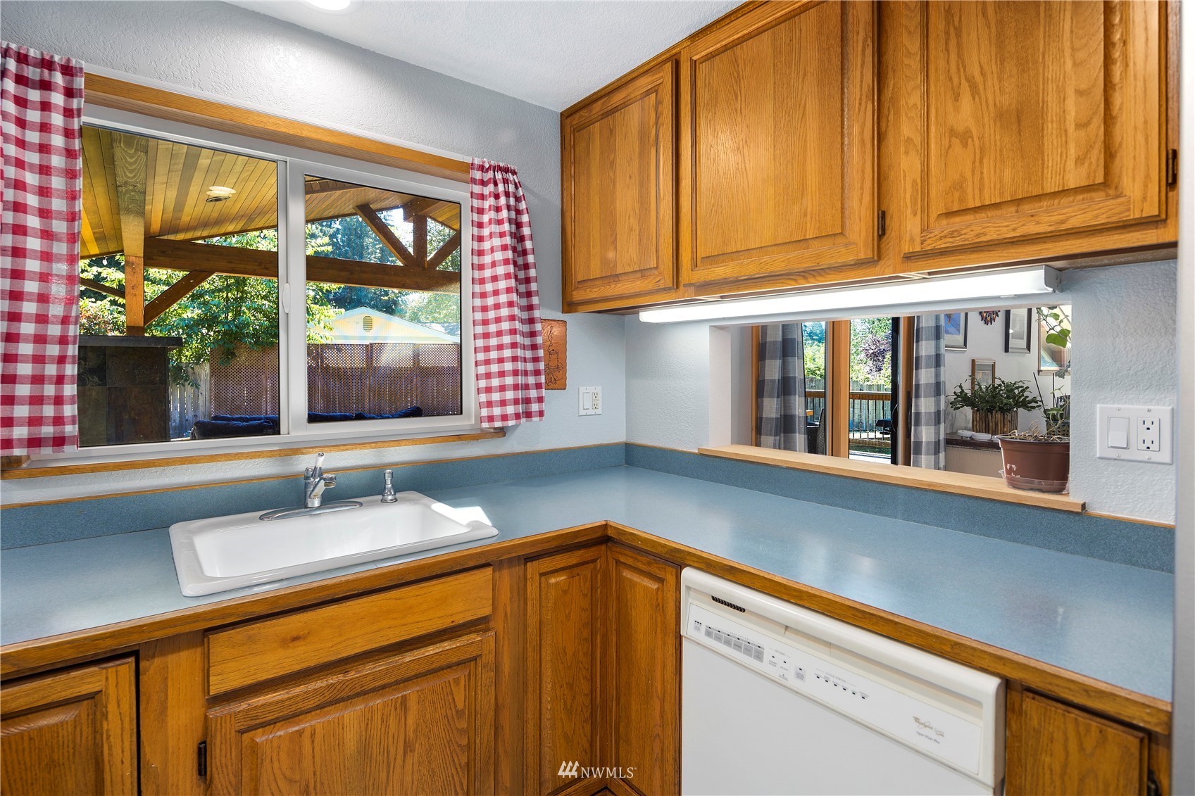 11715 Ingraham Road Snohomish, WA 98290 - Photo 11 of 38 a kitchen with granite countertop wooden cabinets a sink and a window