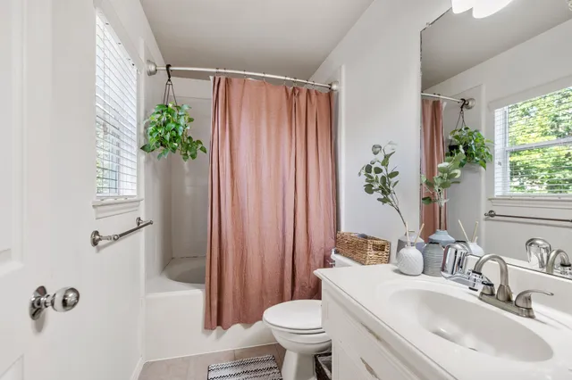 a bedroom with a large bed and a night stand