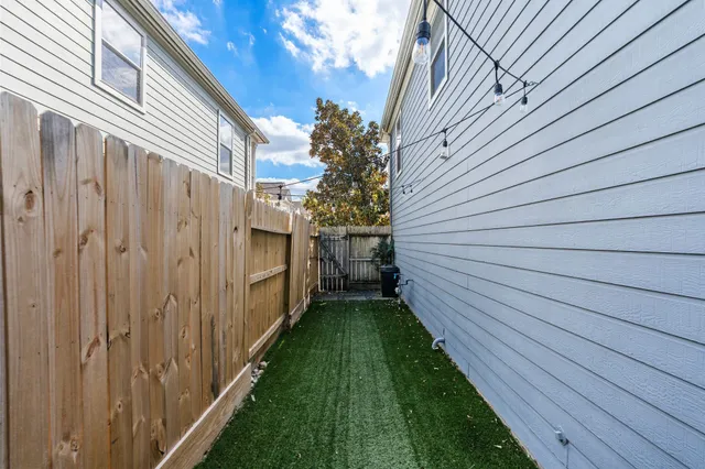 a view of a backyard with wooden fence
