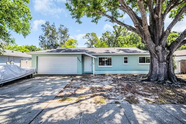 a view of a house with a tree in the background