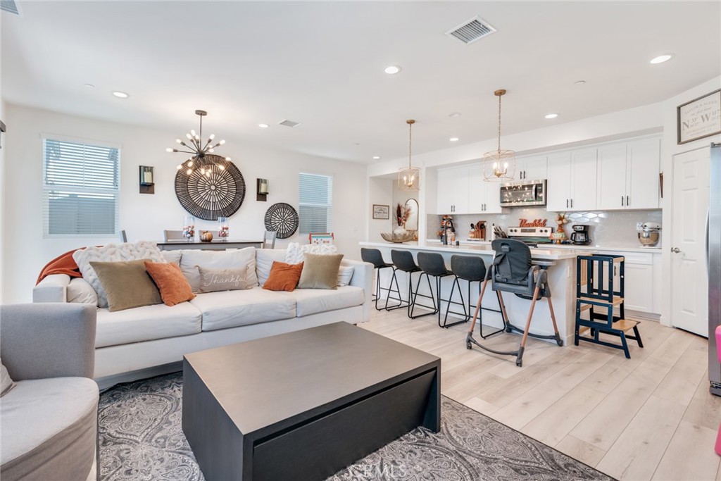 4247 Bravado Court Riverside, CA 92505 - Photo 1 of 33 a living room with lots of furniture and kitchen view