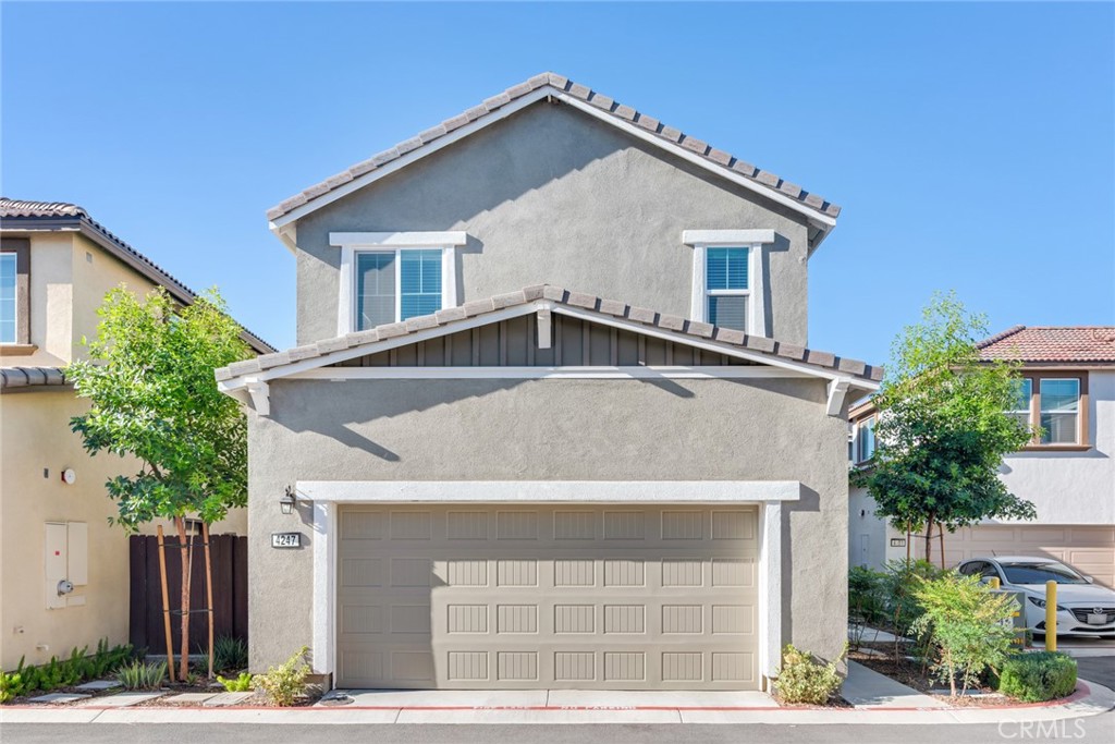 4247 Bravado Court Riverside, CA 92505 - Photo 2 of 33 a front view of a house with a yard and garage