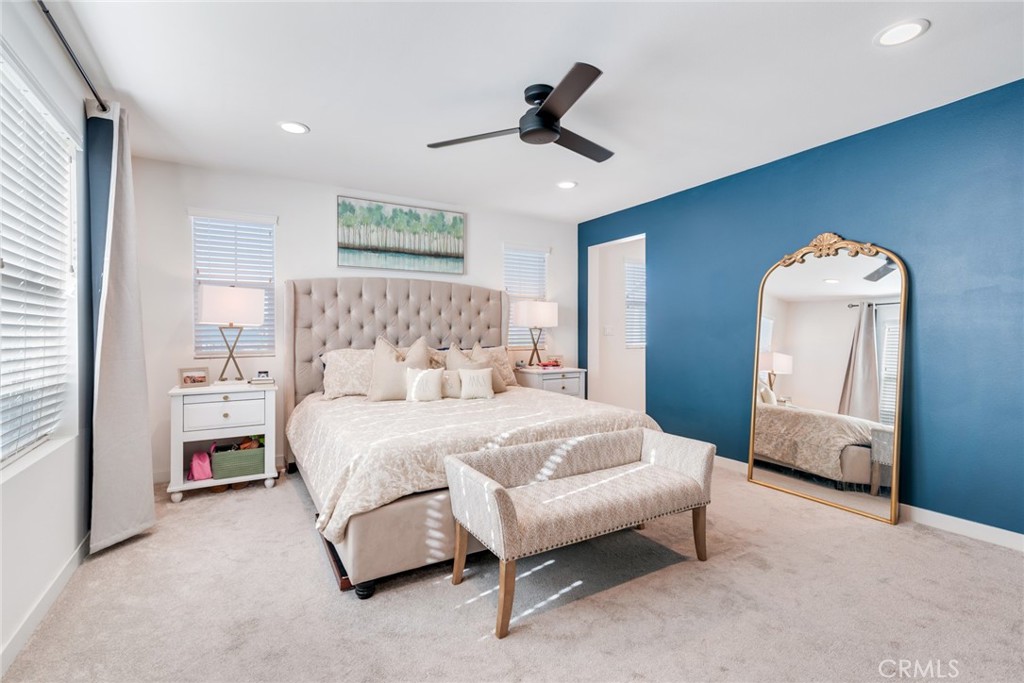 4247 Bravado Court Riverside, CA 92505 - Photo 25 of 33 a spacious bedroom with a bed and a chandelier