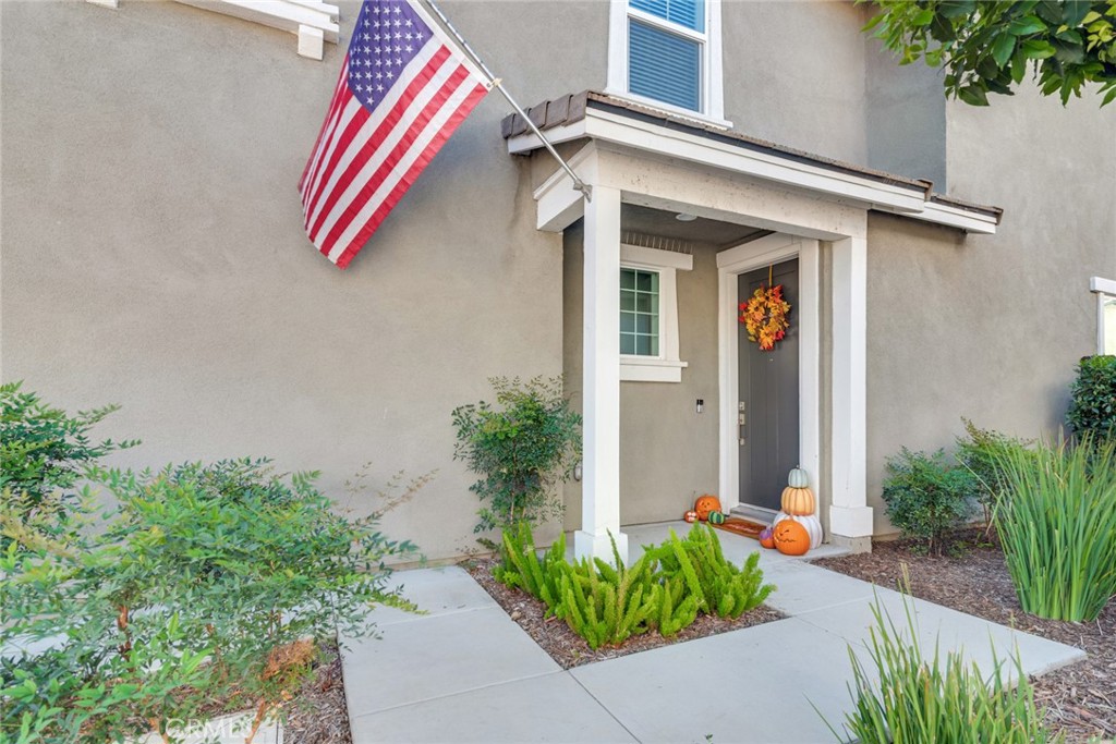 4247 Bravado Court Riverside, CA 92505 - Photo 3 of 33 a front view of a house with potted plants