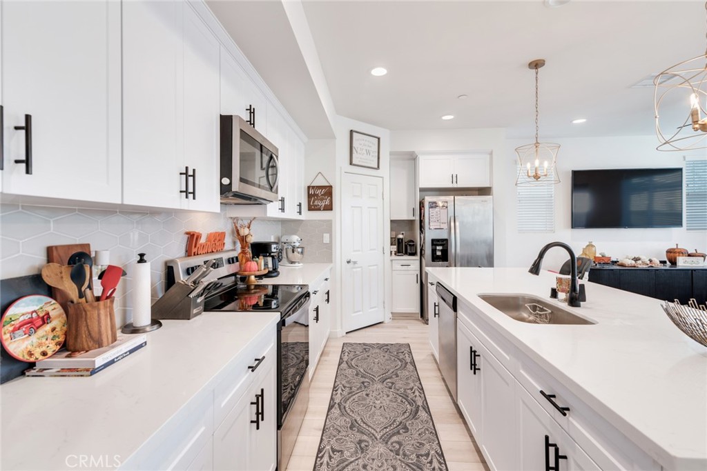 4247 Bravado Court Riverside, CA 92505 - Photo 7 of 33 a view of a kitchen with sink and dishwasher