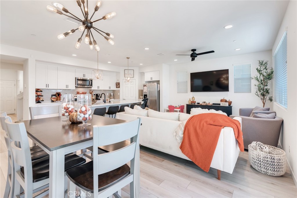 4247 Bravado Court Riverside, CA 92505 - Photo 10 of 33 a living room with stainless steel appliances furniture a fireplace and a flat screen tv