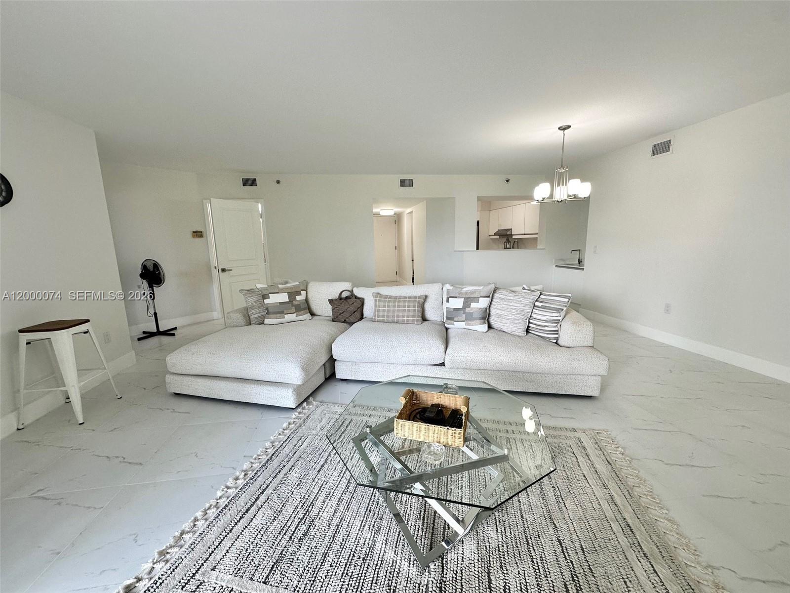 8925 Collins Avenue, Unit 2J Surfside, FL 33154 - Photo 11 of 63 a living room with furniture and a wooden floor