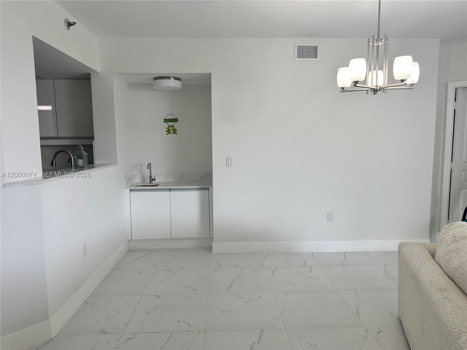 8925 Collins Avenue, Unit 2J Surfside, FL 33154 - Photo 15 of 63 a view of a kitchen with a sink and chandelier