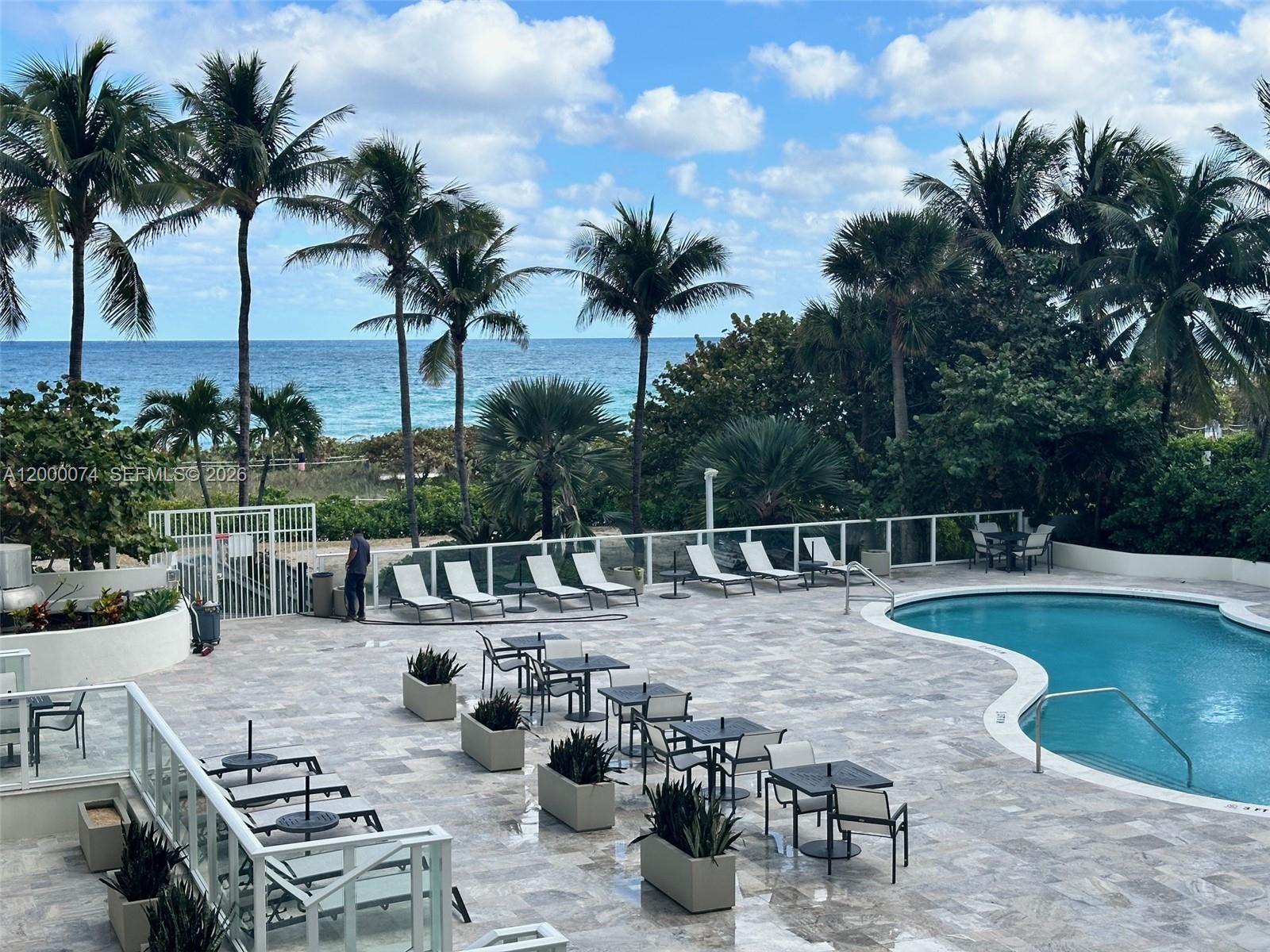 8925 Collins Avenue, Unit 2J Surfside, FL 33154 - Photo 2 of 63 a view of a backyard with swimming pool and sitting area