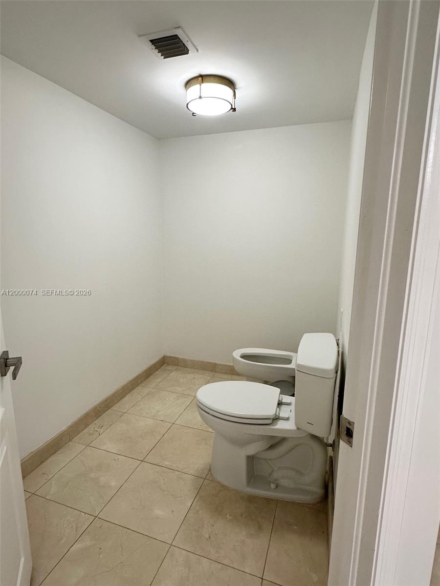 8925 Collins Avenue, Unit 2J Surfside, FL 33154 - Photo 22 of 63 a bathroom with a toilet