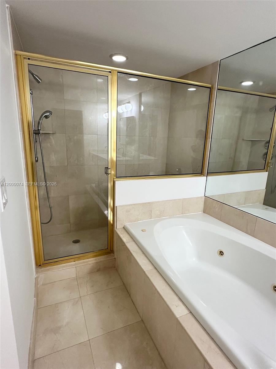 8925 Collins Avenue, Unit 2J Surfside, FL 33154 - Photo 23 of 63 a bathroom with a bathtub and a shower
