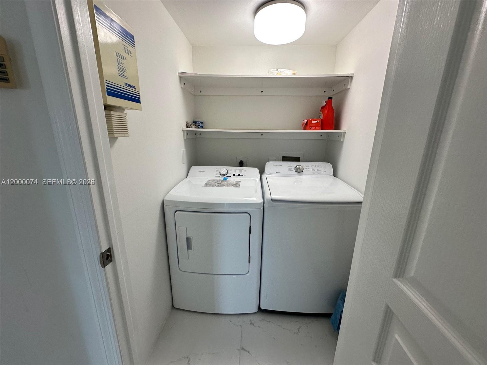 8925 Collins Avenue, Unit 2J Surfside, FL 33154 - Photo 28 of 63 a utility room with dryer and washer