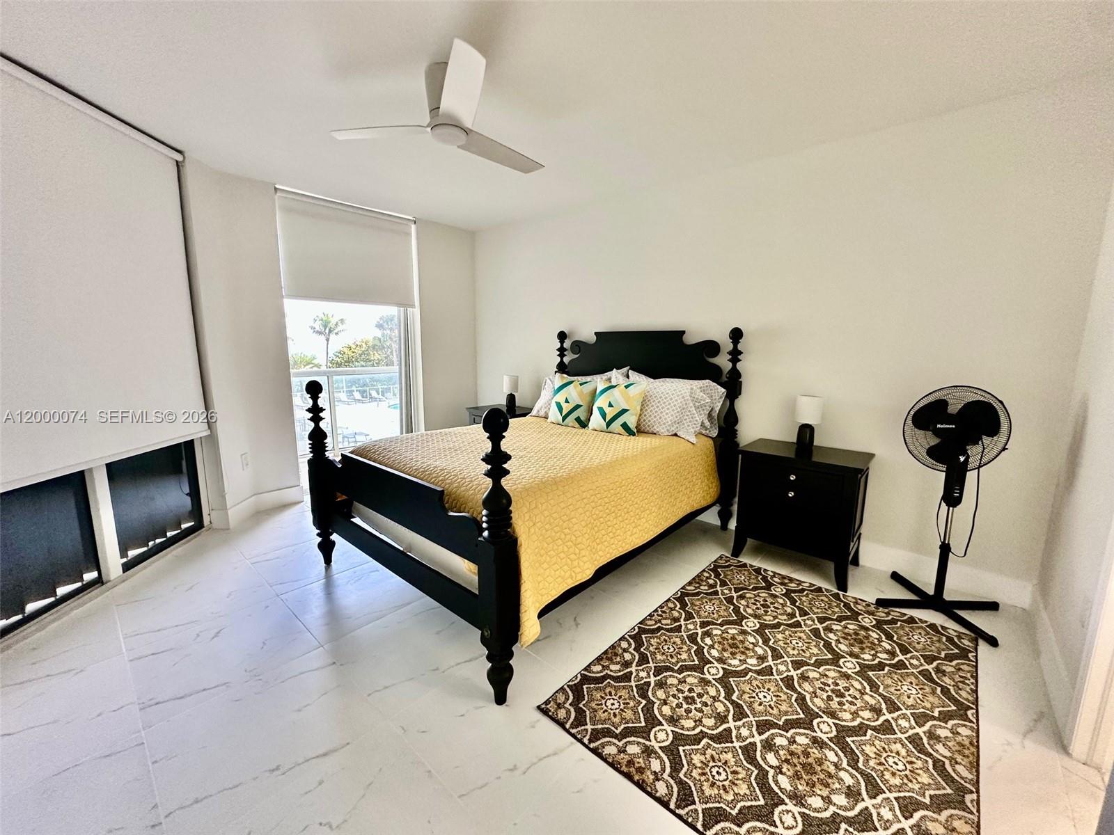 8925 Collins Avenue, Unit 2J Surfside, FL 33154 - Photo 30 of 63 a bedroom with a bed and a fireplace